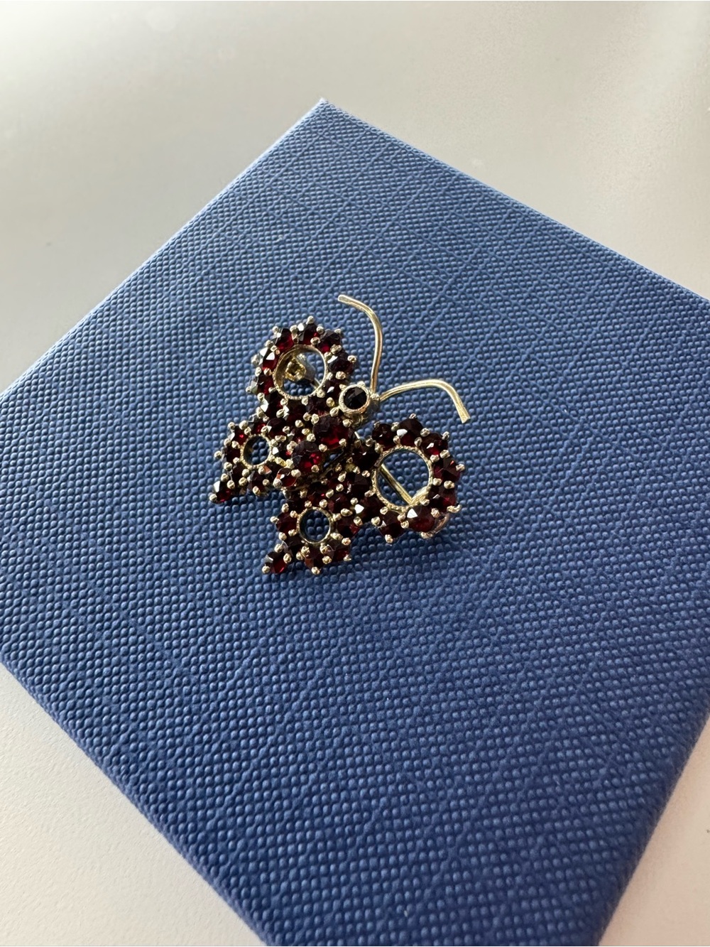 Gold Butterfly Drop Earrings with Red Gem Clusters